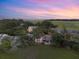 Aerial view of the community at sunset, showcasing homes and marsh at 1239 Creek Watch, Seabrook Island, SC 29455