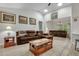 Spacious living room with vaulted ceilings, a brown leather sectional sofa and a gas fireplace at 516 Yellow Leaf Ln, Summerville, SC 29486