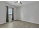 Simple bedroom with gray walls, wood-look floors, and green curtains at 516 Yellow Leaf Ln, Summerville, SC 29486