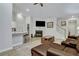 Open living room with kitchen island, gas fireplace and a brown leather sectional at 516 Yellow Leaf Ln, Summerville, SC 29486