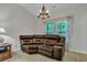 Sitting room features a brown leather sectional sofa and a wooden chandelier at 516 Yellow Leaf Ln, Summerville, SC 29486