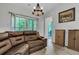 Sitting room features a brown leather sectional and access to backyard patio at 516 Yellow Leaf Ln, Summerville, SC 29486