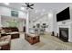 Open living room with a fireplace, kitchen view, and brown sectional sofa at 516 Yellow Leaf Ln, Summerville, SC 29486