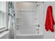 White bathroom with shower/tub combo, red towel, and floral curtain at 516 Yellow Leaf Ln, Summerville, SC 29486