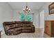 Sitting room with a brown leather sectional sofa and large windows at 516 Yellow Leaf Ln, Summerville, SC 29486