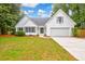 White charming one-story house with a two-car garage at 1094 Honeysuckle Ln, Charleston, SC 29412