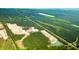 Aerial view of a new community development with lots of green space and ponds at 5528 Bowmore Blvd, Ravenel, SC 29470