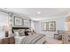Main bedroom with king-size bed, sitting area, and large windows at 5528 Bowmore Blvd, Ravenel, SC 29470