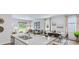 Open kitchen with granite island, double sink, and view into adjacent living area at 5528 Bowmore Blvd, Ravenel, SC 29470
