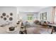 Open floor plan with kitchen, island, and adjacent living room with access to backyard at 5528 Bowmore Blvd, Ravenel, SC 29470