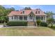 Two-story house with red metal roof, front porch, and landscaped yard at 108 N Norfolk Way, Goose Creek, SC 29445