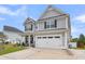 Two-story gray house with white garage door and a well-manicured lawn at 515 Alderly Dr, Moncks Corner, SC 29461