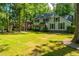 Two-story house with gray siding, a brick base, and a large yard at 107 Tryon Dr, Summerville, SC 29485