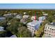 Aerial view highlighting a charming white house nestled amongst other homes near the water at 3006 Cameron Blvd, Isle of Palms, SC 29451