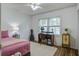 Cozy bedroom with a pink comforter, writing desk, and wood-look flooring at 213 Blue Heron Dr, Summerville, SC 29485