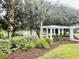 White pergola and landscaping near a pond in a community at 105 Covey Rise Ct, Summerville, SC 29485