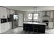 Modern kitchen with white cabinets, a large island, and stainless steel appliances at 928 Tiger Loop, Saint Stephen, SC 29479