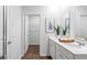 Double vanity bathroom with linen closet and hardwood floors at 6281 Gritman Dr, Hollywood, SC 29470