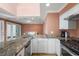Open kitchen with granite countertops, stainless steel appliances, and hardwood floors at 1616 Live Oak Park, Seabrook Island, SC 29455