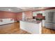 Open kitchen with granite countertops, stainless steel appliances, and hardwood floors at 1616 Live Oak Park, Seabrook Island, SC 29455