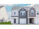 Modern townhouse with two-tone siding, attached garage, and front door at 168 Yarrow Way, Moncks Corner, SC 29461