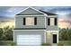 Two-story home with gray siding, white garage door, and black windows at 369 Willows Crescent Dr, Moncks Corner, SC 29461