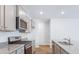 Modern kitchen with stainless steel range, microwave, and gray cabinets at 369 Willows Crescent Dr, Moncks Corner, SC 29461