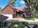 Brick home with metal roof, patio, and attached garage at 1813 Albert Storm Ave, Moncks Corner, SC 29461