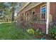 Brick home with covered porch and lawn at 1813 Albert Storm Ave, Moncks Corner, SC 29461