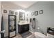 Bathroom with dark vanity, shiplap wall, and modern fixtures at 1229 Updyke Dr, Johns Island, SC 29455