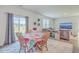 Bright dining area with wooden table and chairs near sliding glass door at 124 Blossom Wood Ln, Summerville, SC 29486