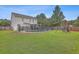 Home with fenced-in pool, grassy yard, and playset at 7160 Sweetgrass Blvd, Hanahan, SC 29410