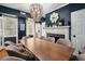 Dark-blue dining room with wooden table and beaded chandelier at 167 Coming St, Charleston, SC 29403