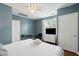 King-size bed with TV in a blue room at 167 Coming St, Charleston, SC 29403