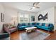 Living room boasts a teal sectional and hardwood floors at 167 Coming St, Charleston, SC 29403