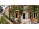Charming yellow house with white columns and lush green vines at 167 Coming St, Charleston, SC 29403