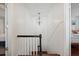White and black staircase with wooden steps and a geometric light fixture at 167 Coming St, Charleston, SC 29403