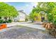 Gravel driveway and small front yard with mature trees at 167 Coming St, Charleston, SC 29403