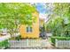 Yellow house with white picket fence and landscaping at 167 Coming St, Charleston, SC 29403