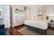Bedroom with a gray bed frame, white fireplace, and hardwood floors at 167 Coming St, Charleston, SC 29403