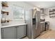 Bright kitchen boasts stainless steel refrigerator and white quartz countertops at 167 Coming St, Charleston, SC 29403