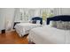 Two twin beds with navy headboards in bright bedroom at 167 Coming St, Charleston, SC 29403