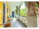 Inviting front porch with white railing, yellow walls, and comfy seating at 167 Coming St, Charleston, SC 29403