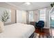 Bedroom with a bed, blue velvet chair, and hardwood floors at 167 Coming St, Charleston, SC 29403