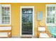 Home exterior featuring a black front door and yellow siding at 167 Coming St, Charleston, SC 29403