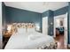 Blue-walled bedroom with king-size bed and access to living room at 167 Coming St, Charleston, SC 29403