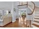 Elegant curved staircase with hardwood treads and white railings at 3427 Colonel Vanderhorst Cir, Mount Pleasant, SC 29466