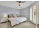 Spacious bedroom with a ceiling fan, double doors leading to a balcony, and plush bedding at 3427 Colonel Vanderhorst Cir, Mount Pleasant, SC 29466