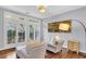 Relaxing sitting area with two armchairs, ottoman, and wood floors at 3427 Colonel Vanderhorst Cir, Mount Pleasant, SC 29466