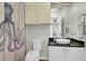 Clean bathroom with a vessel sink, granite countertop, and an octopus shower curtain at 3427 Colonel Vanderhorst Cir, Mount Pleasant, SC 29466